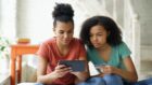 Two young women looking at a tablet device.