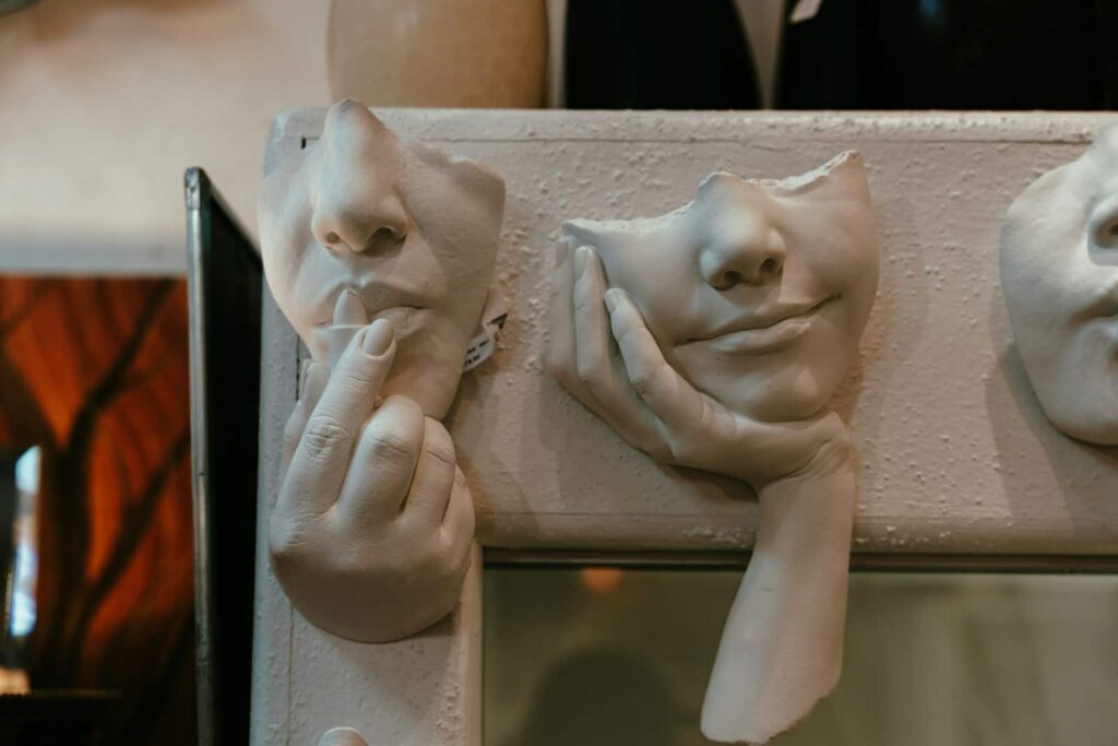 A close up of a couple of masks on a wall